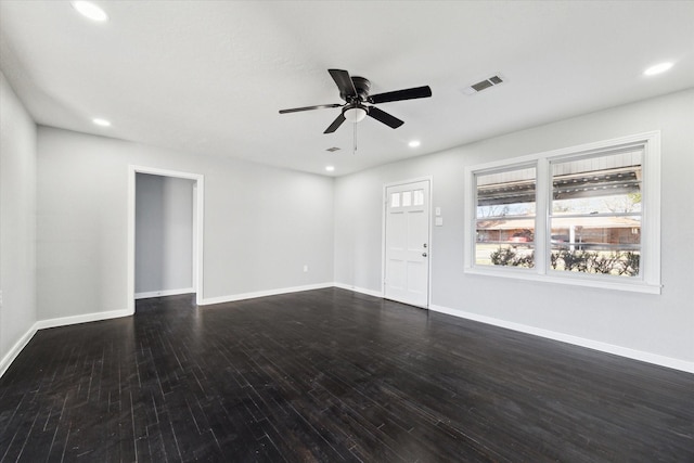 unfurnished living room featuring dark wood-type flooring and ceiling fan