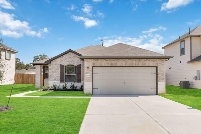 single story home with central AC unit, a front lawn, and a garage