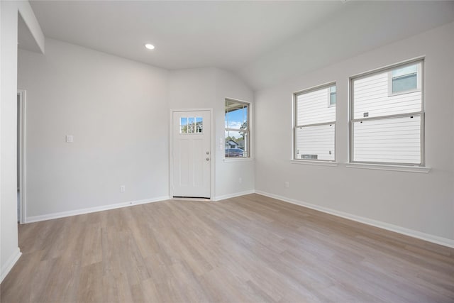 interior space with lofted ceiling and light wood-type flooring