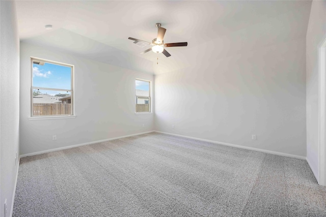 empty room with ceiling fan and carpet