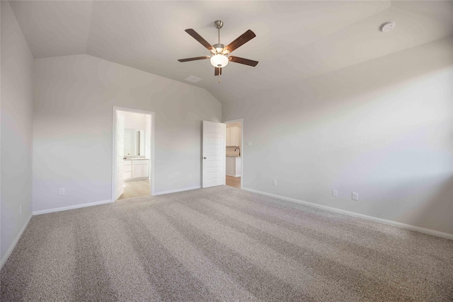 unfurnished bedroom featuring ceiling fan, carpet, connected bathroom, and high vaulted ceiling