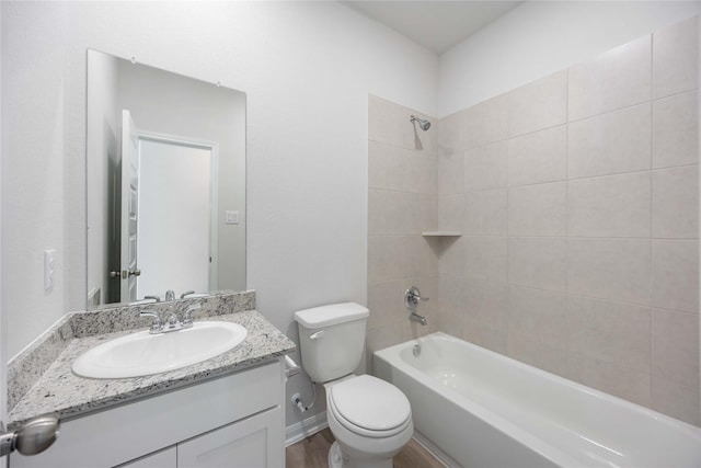 full bathroom with toilet, tiled shower / bath combo, hardwood / wood-style floors, and vanity