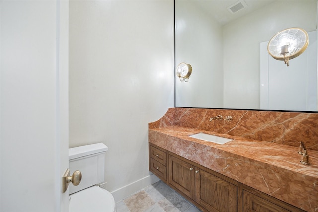 bathroom featuring vanity and toilet