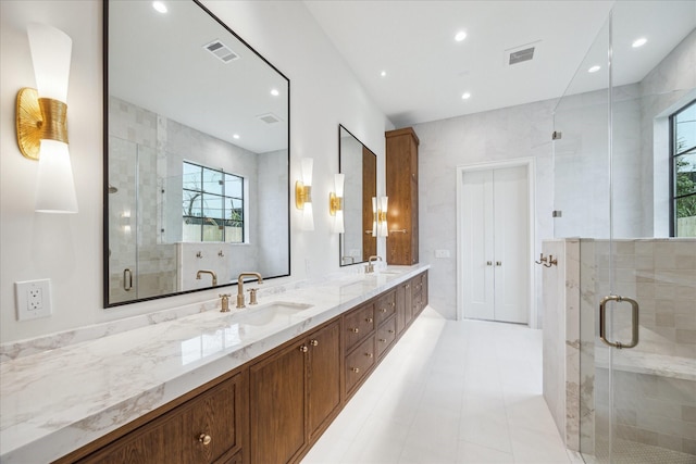 bathroom featuring vanity, an enclosed shower, and tile walls