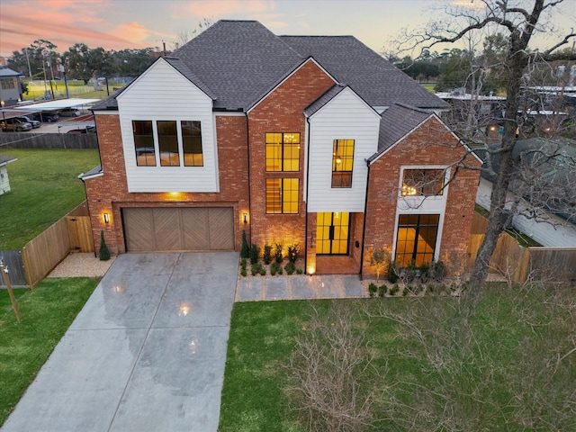 view of front of home with a garage and a yard