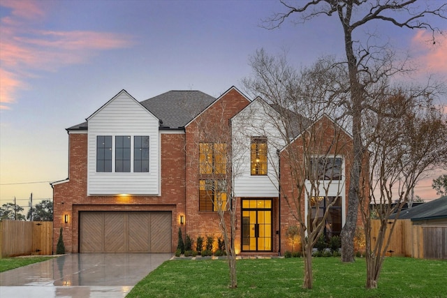 view of front of house with a yard and a garage