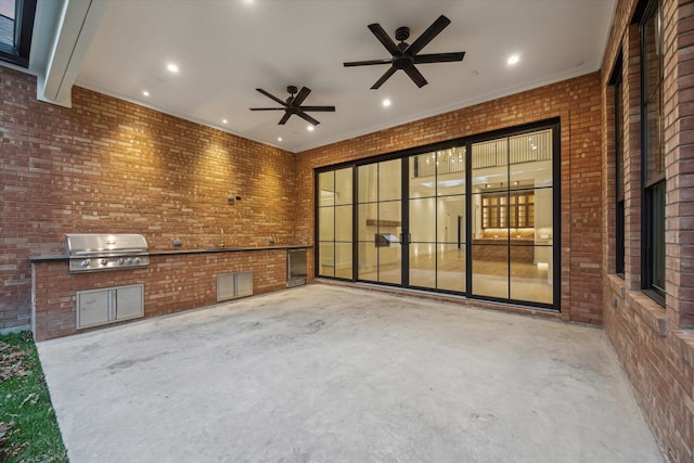 view of patio / terrace with grilling area, ceiling fan, and an outdoor kitchen