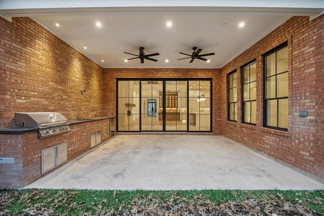 view of patio / terrace featuring an outdoor kitchen, area for grilling, sink, and ceiling fan