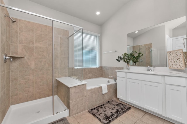 bathroom featuring vanity, lofted ceiling, separate shower and tub, and tile patterned flooring