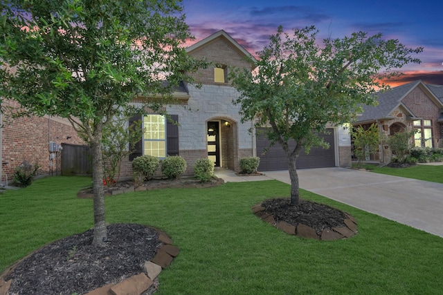 view of front of home with a garage and a lawn