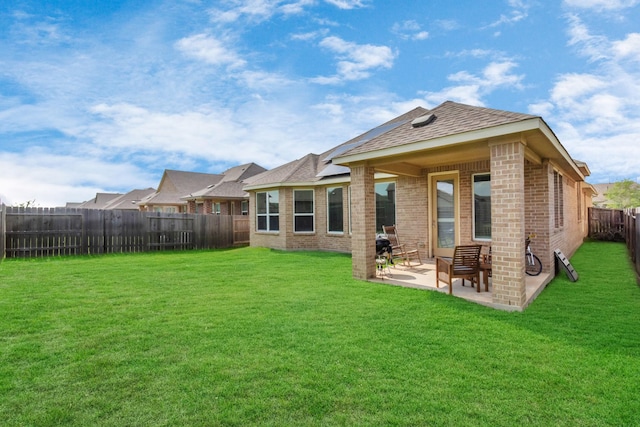 rear view of house with a patio area and a yard