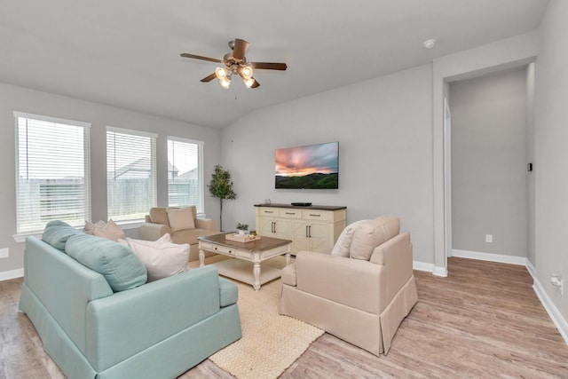 living room with ceiling fan, lofted ceiling, and light wood-type flooring