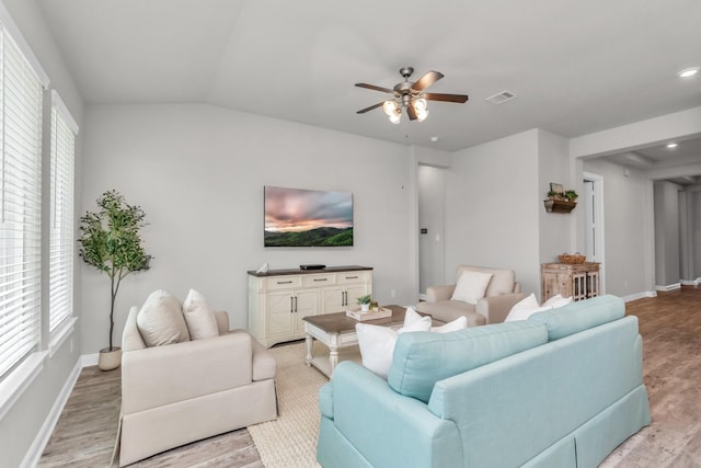 living room with vaulted ceiling, ceiling fan, and light hardwood / wood-style flooring