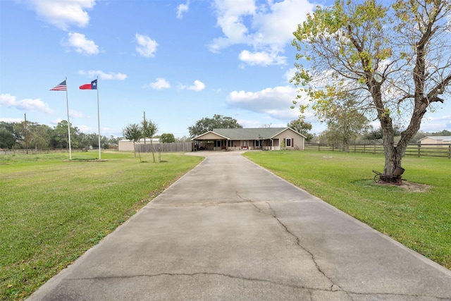 view of front facade with a front yard and a carport