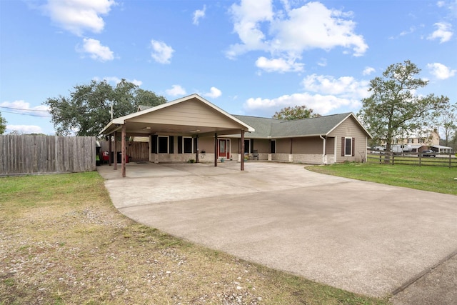 view of front of home with a front lawn and a carport