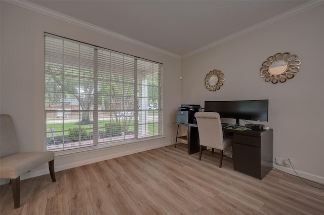 home office with light wood-type flooring, plenty of natural light, and ornamental molding