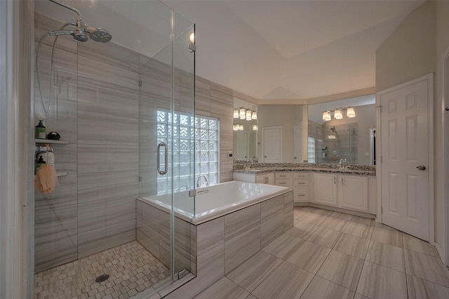 bathroom featuring vanity, lofted ceiling, and separate shower and tub