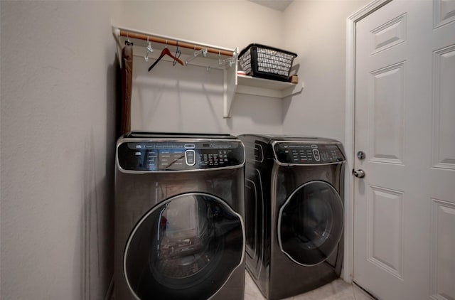 laundry area with light tile patterned flooring and independent washer and dryer