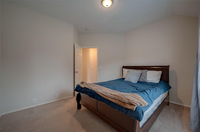 carpeted bedroom featuring lofted ceiling