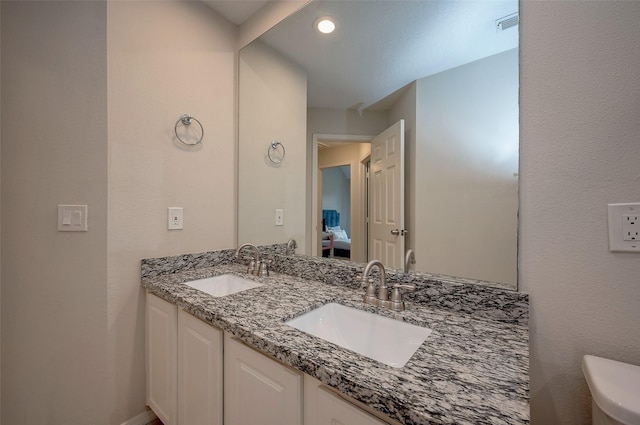 bathroom with toilet and vanity