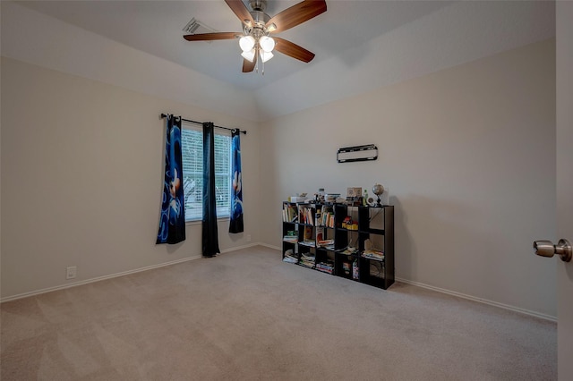 empty room featuring ceiling fan, vaulted ceiling, and light carpet