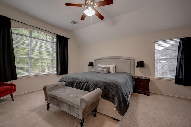 bedroom featuring light carpet, ceiling fan, lofted ceiling, and multiple windows