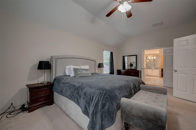 carpeted bedroom with ceiling fan, lofted ceiling, and connected bathroom