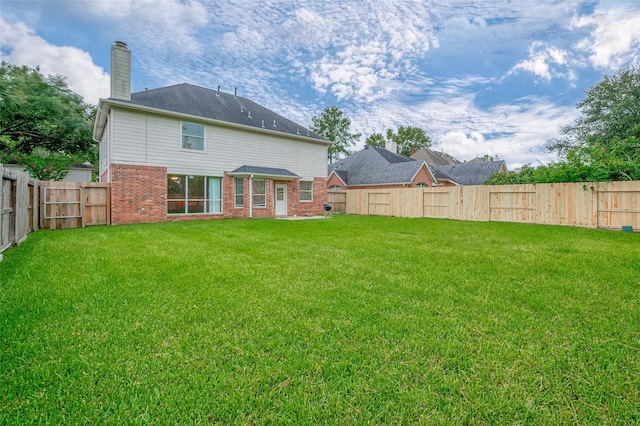 back of property featuring a lawn