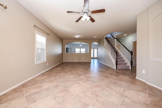 tiled empty room featuring ceiling fan