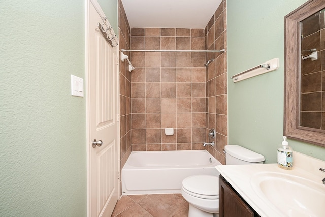 full bathroom featuring toilet, tile patterned flooring, tiled shower / bath combo, and vanity