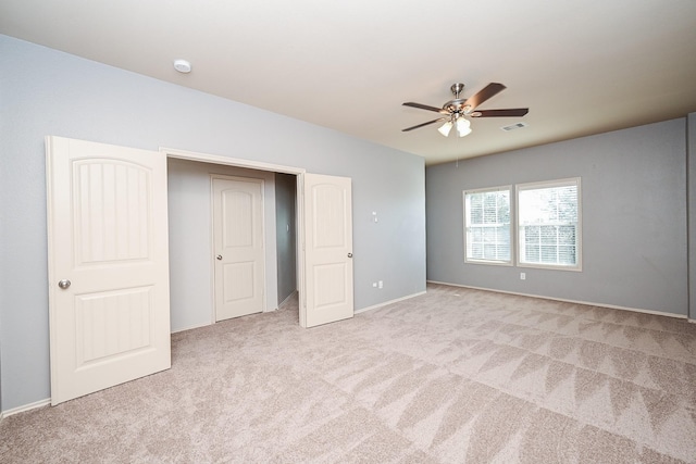 unfurnished bedroom featuring ceiling fan and light colored carpet