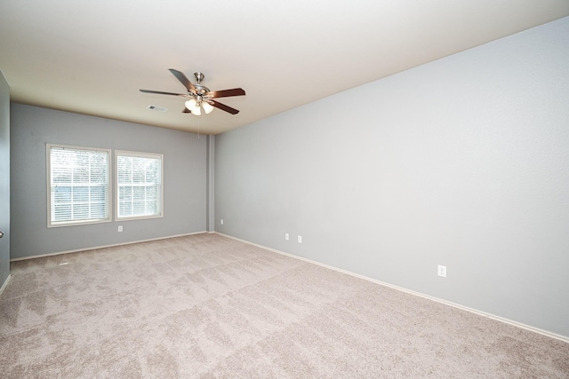 carpeted spare room with ceiling fan