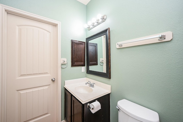 bathroom with toilet and vanity