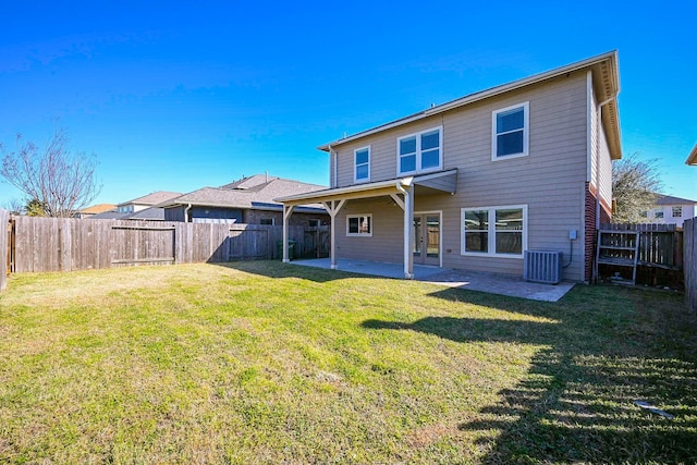 rear view of property with central AC, a patio, and a yard