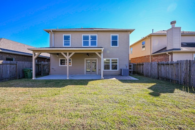 rear view of house featuring ceiling fan, a patio area, cooling unit, and a lawn