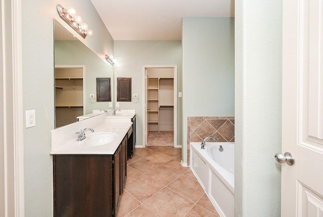 bathroom featuring vanity, tile patterned flooring, and a bathing tub