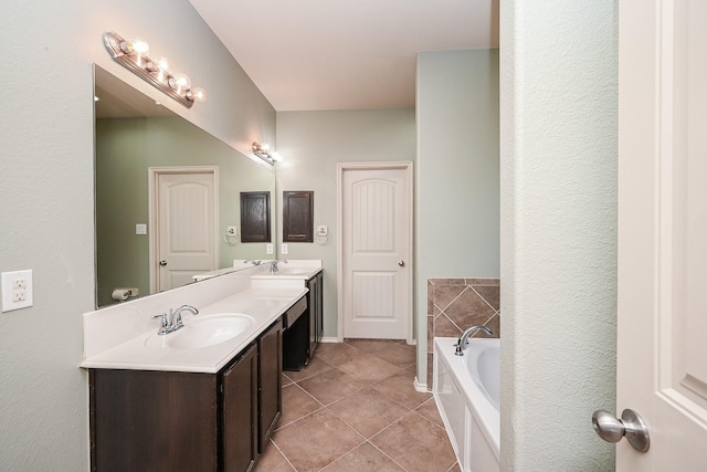 bathroom featuring vanity, a tub, and tile patterned floors