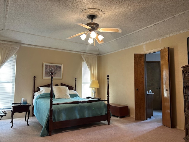 carpeted bedroom with ceiling fan, vaulted ceiling, and a textured ceiling