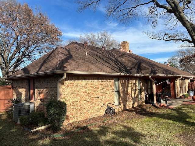 back of house featuring a patio area, cooling unit, and a lawn