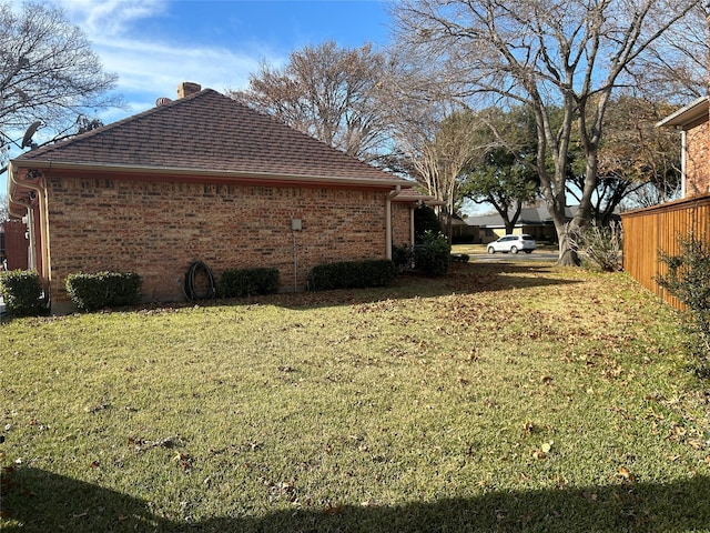 view of side of home with a lawn