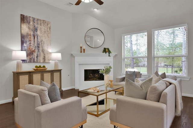 living room with hardwood / wood-style floors, vaulted ceiling, and ceiling fan