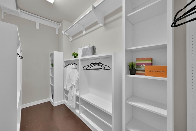 spacious closet with dark wood-type flooring