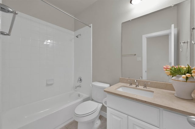 full bathroom featuring tile patterned flooring, vanity, tiled shower / bath, and toilet