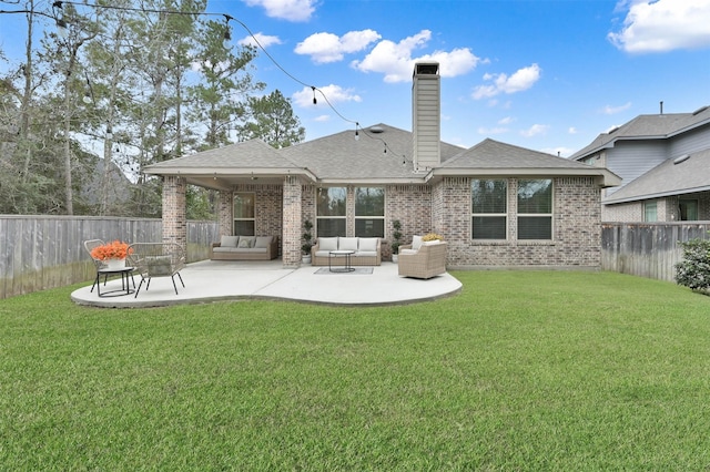 back of property with a yard, an outdoor hangout area, and a patio area