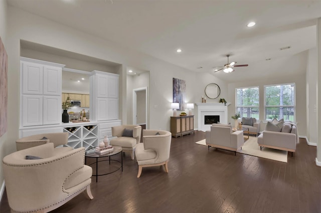 living room with ceiling fan and dark hardwood / wood-style flooring