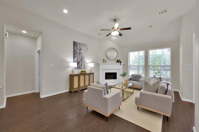 living room featuring vaulted ceiling, dark hardwood / wood-style floors, and ceiling fan