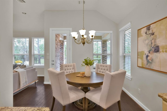 dining area with lofted ceiling, a chandelier, and dark hardwood / wood-style flooring