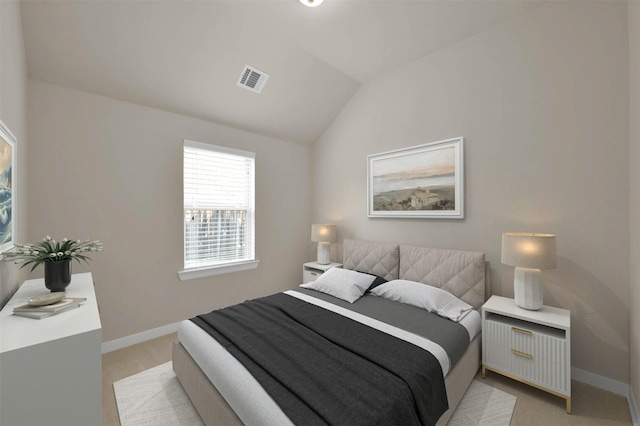 carpeted bedroom featuring lofted ceiling