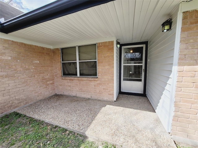 doorway to property with a patio area