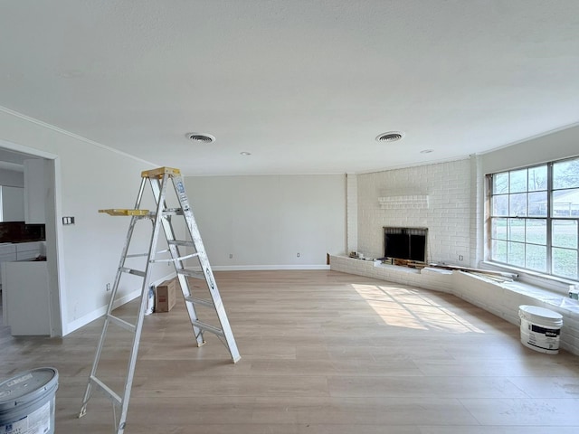 unfurnished living room featuring wood-type flooring and a fireplace